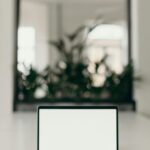 A minimalist workspace featuring an open laptop in a bright, serene indoor setting.